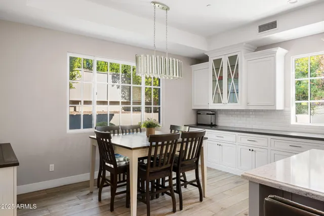 a view of a dining room that has a table and chairs in it