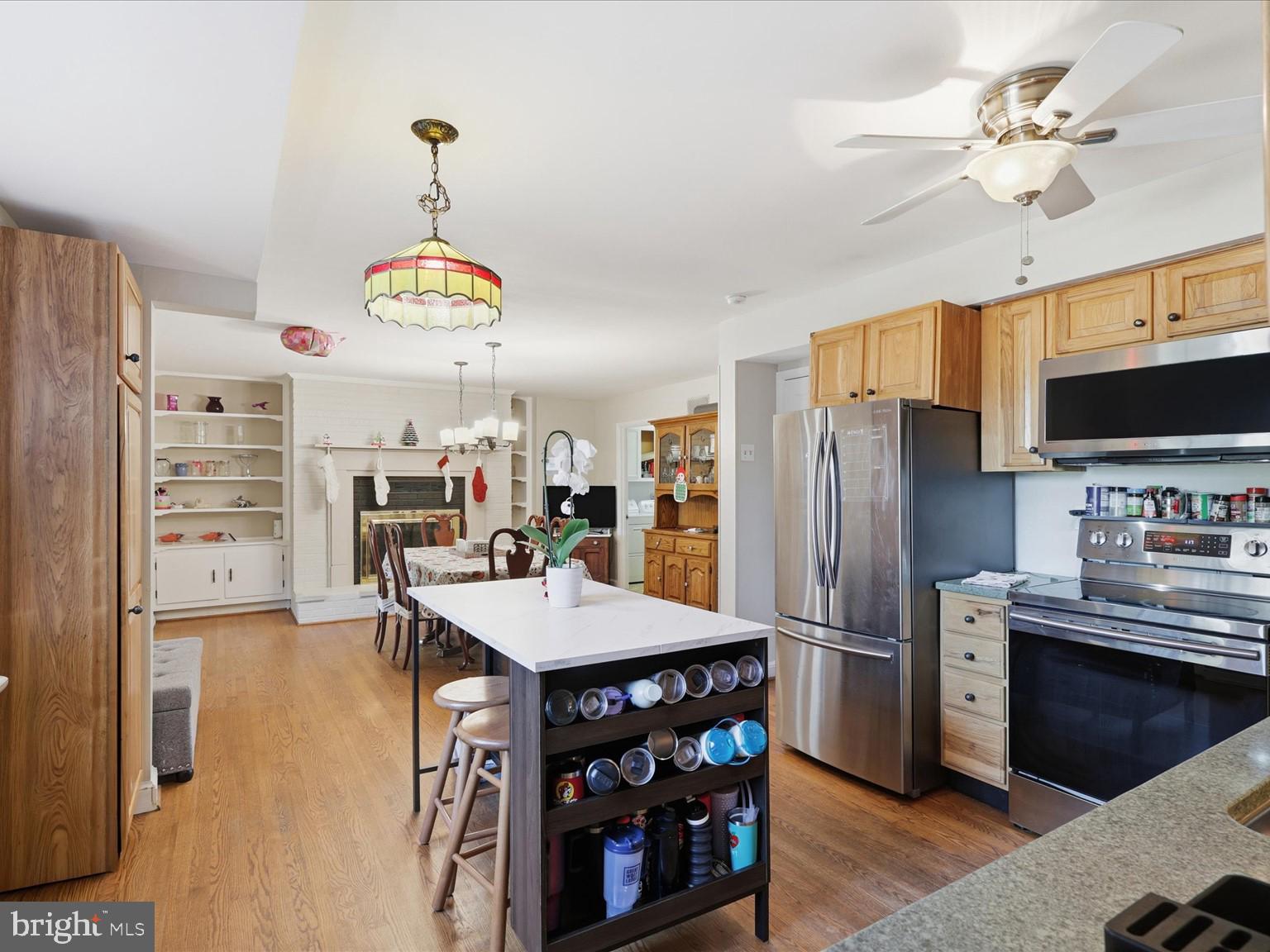 11130 Chapel Road Fairfax Station, VA 22039 - Photo 29 of 55 a kitchen with stainless steel appliances a stove refrigerator and microwave