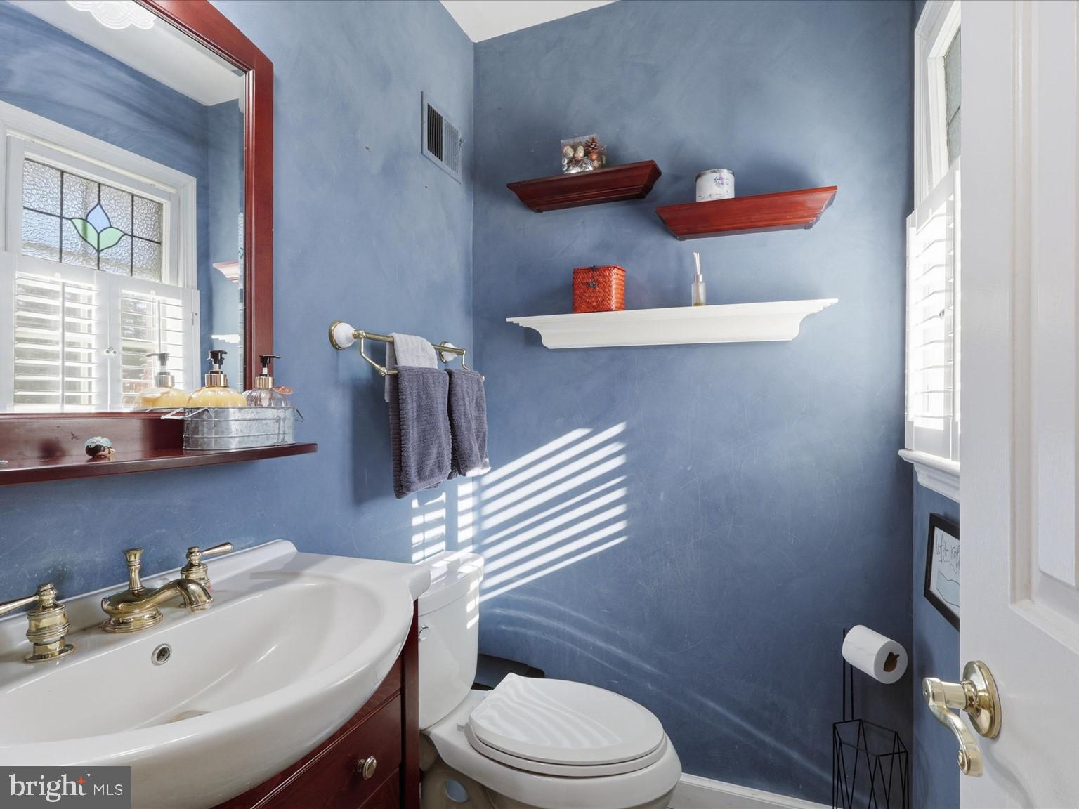 11130 Chapel Road Fairfax Station, VA 22039 - Photo 31 of 55 a bathroom with a sink a toilet and a mirror