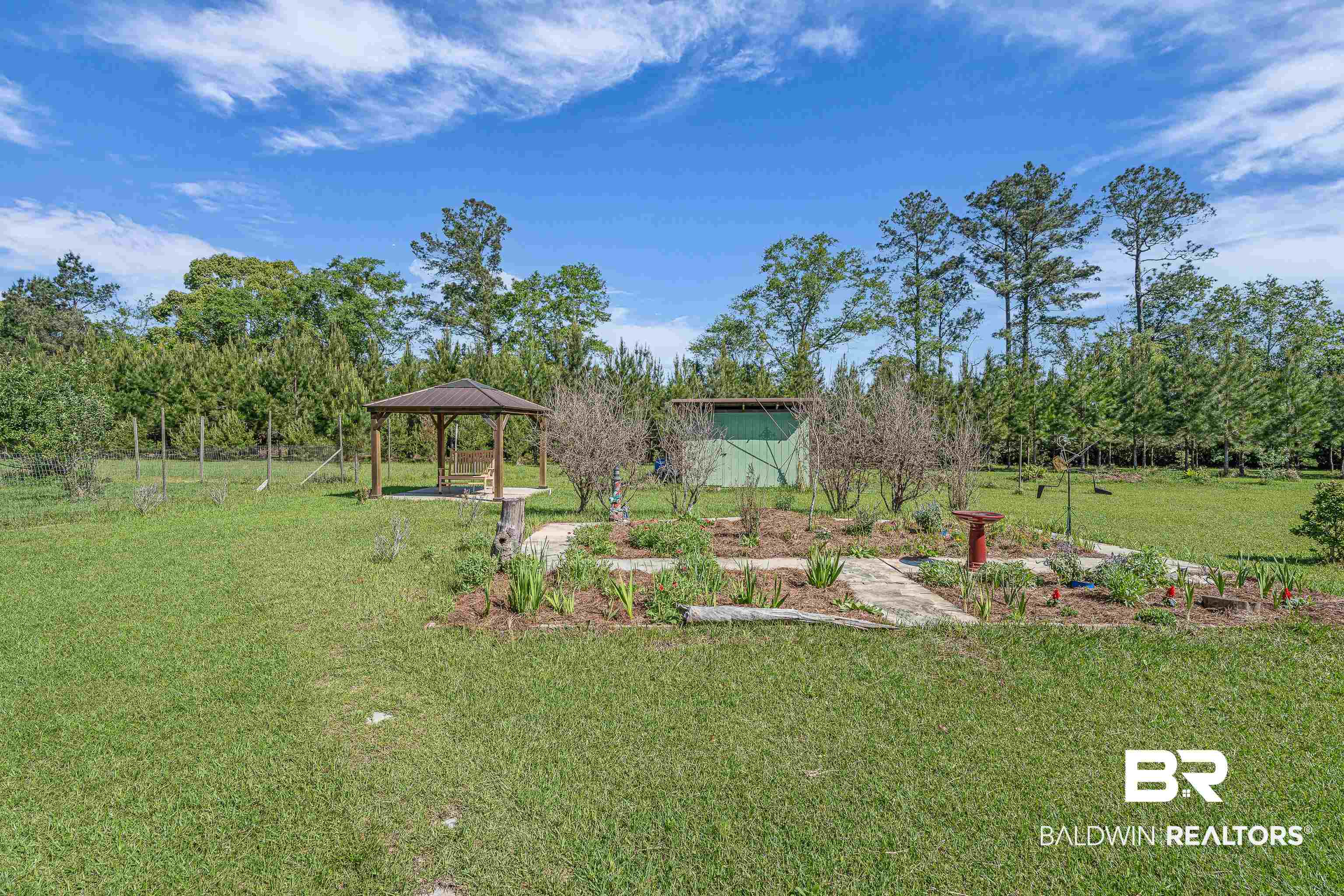 18255 Cactus Court Elberta, AL 36530 - Photo 34 of 53 View of grassy yard featuring a gazebo, a patio area, and view of wooded area