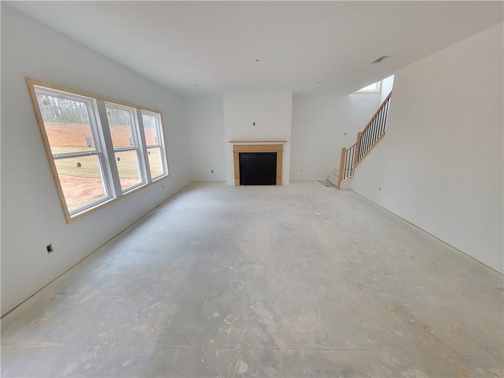 280 Silverleaf Trail Bethlehem, GA 30620 - Photo 8 of 25 a view of empty room with windows and fireplace