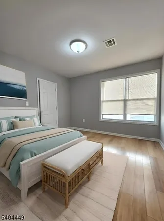 a bedroom with a bed and window