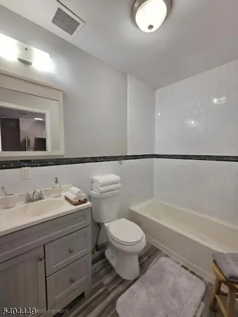 a bathroom with a toilet a sink and bathtub