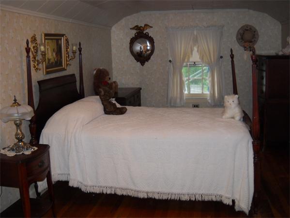 156 Whitney Road Ashby, MA 01431 - Photo 8 of 15 a bedroom with a bed and a chandelier