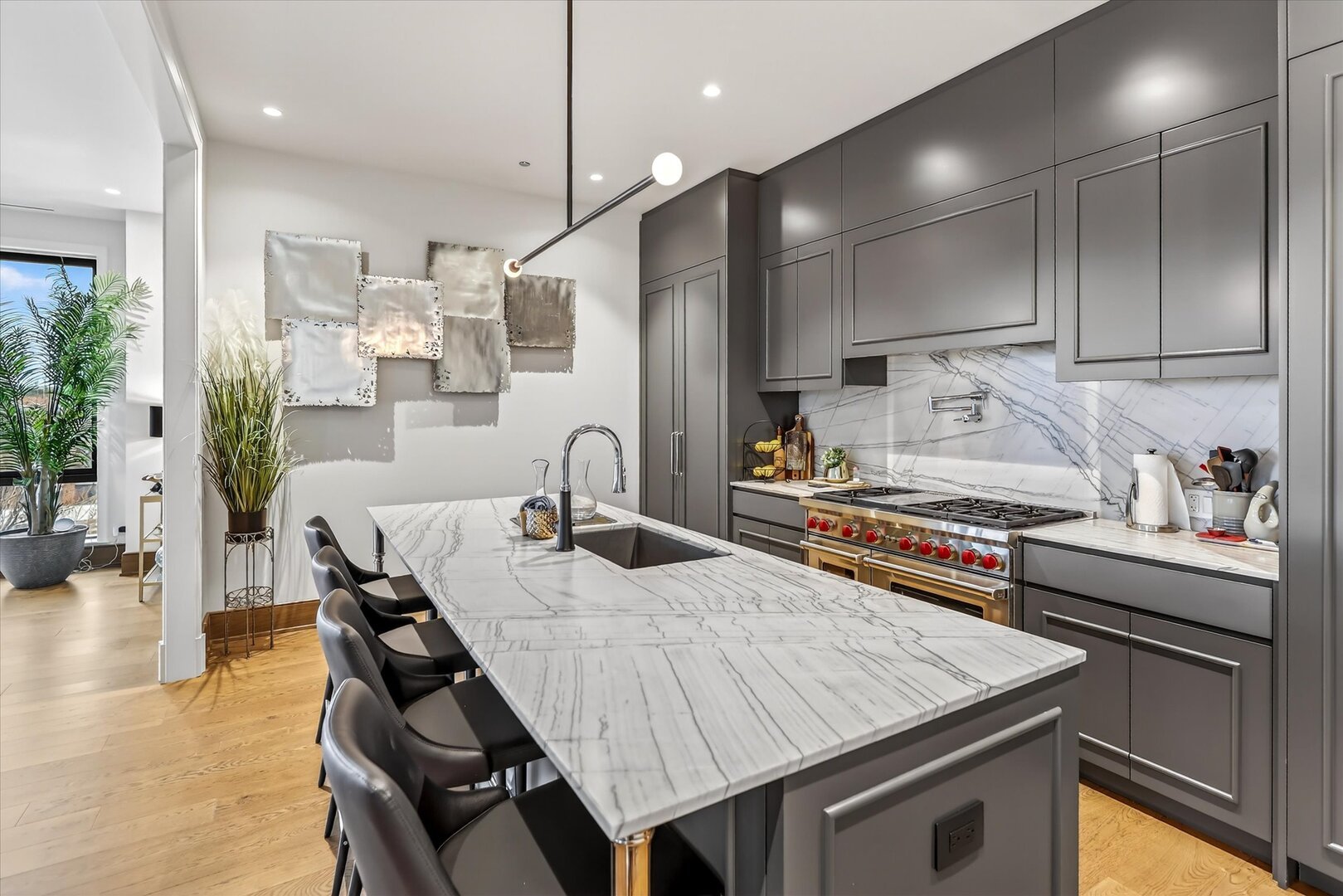 21 North May Street, Unit 501 Chicago, IL 60607 - Photo 26 of 82 a kitchen with stainless steel appliances kitchen island granite countertop a table chairs in it and wooden floors