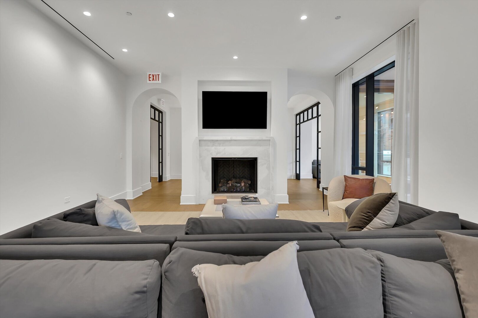 21 North May Street, Unit 501 Chicago, IL 60607 - Photo 72 of 82 a living room with furniture a flat screen tv and a fireplace
