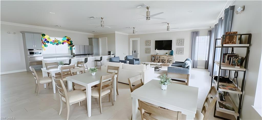 1063 Enbrook Loop Naples, FL 34114 - Photo 25 of 26 Dining space with a ceiling fan and crown molding