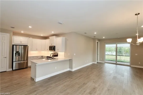 a kitchen with stainless steel appliances granite countertop a refrigerator and a stove