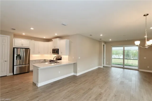 a kitchen with stainless steel appliances granite countertop a refrigerator and a stove