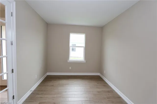 wooden floor in an empty room with a window