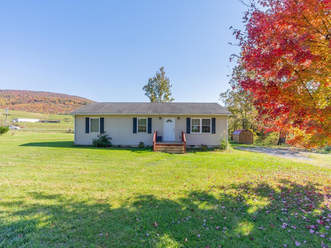 49 See Lane Mathias, WV 26812 - Photo 2 of 55 a front view of a house with a garden
