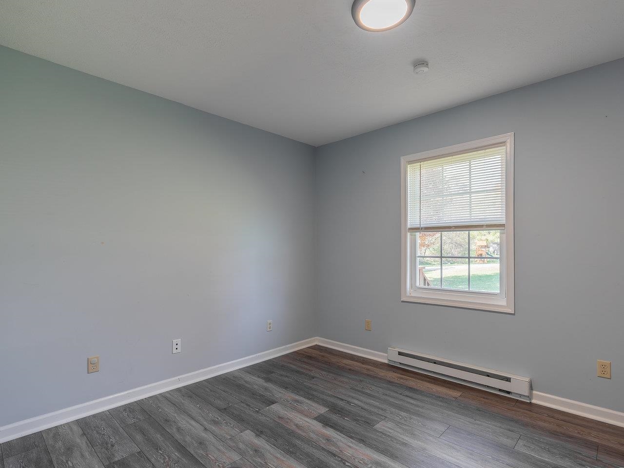 49 See Lane Mathias, WV 26812 - Photo 28 of 55 an empty room with wooden floor and windows