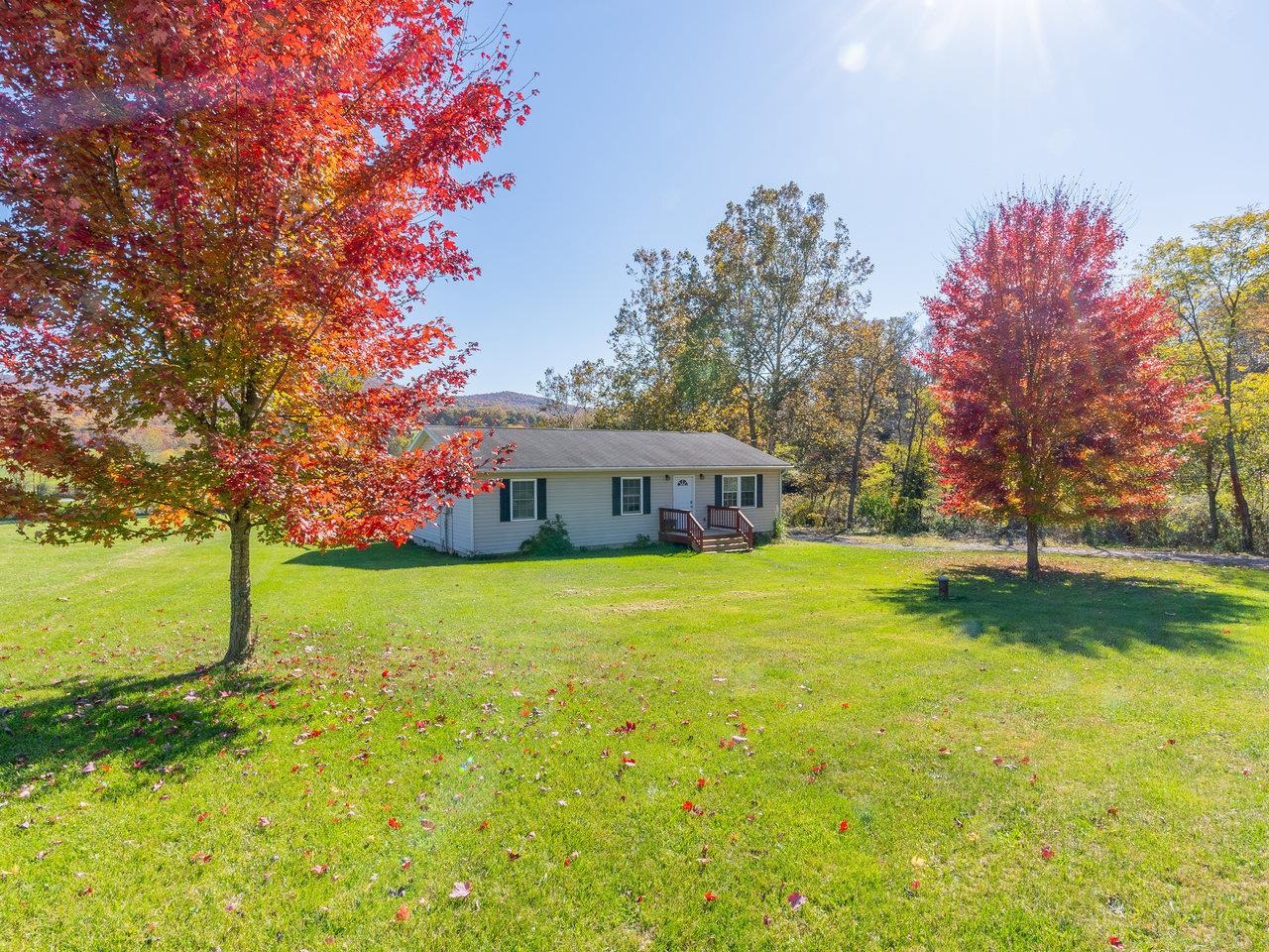 49 See Lane Mathias, WV 26812 - Photo 3 of 55 a backyard of a house with lots of green space