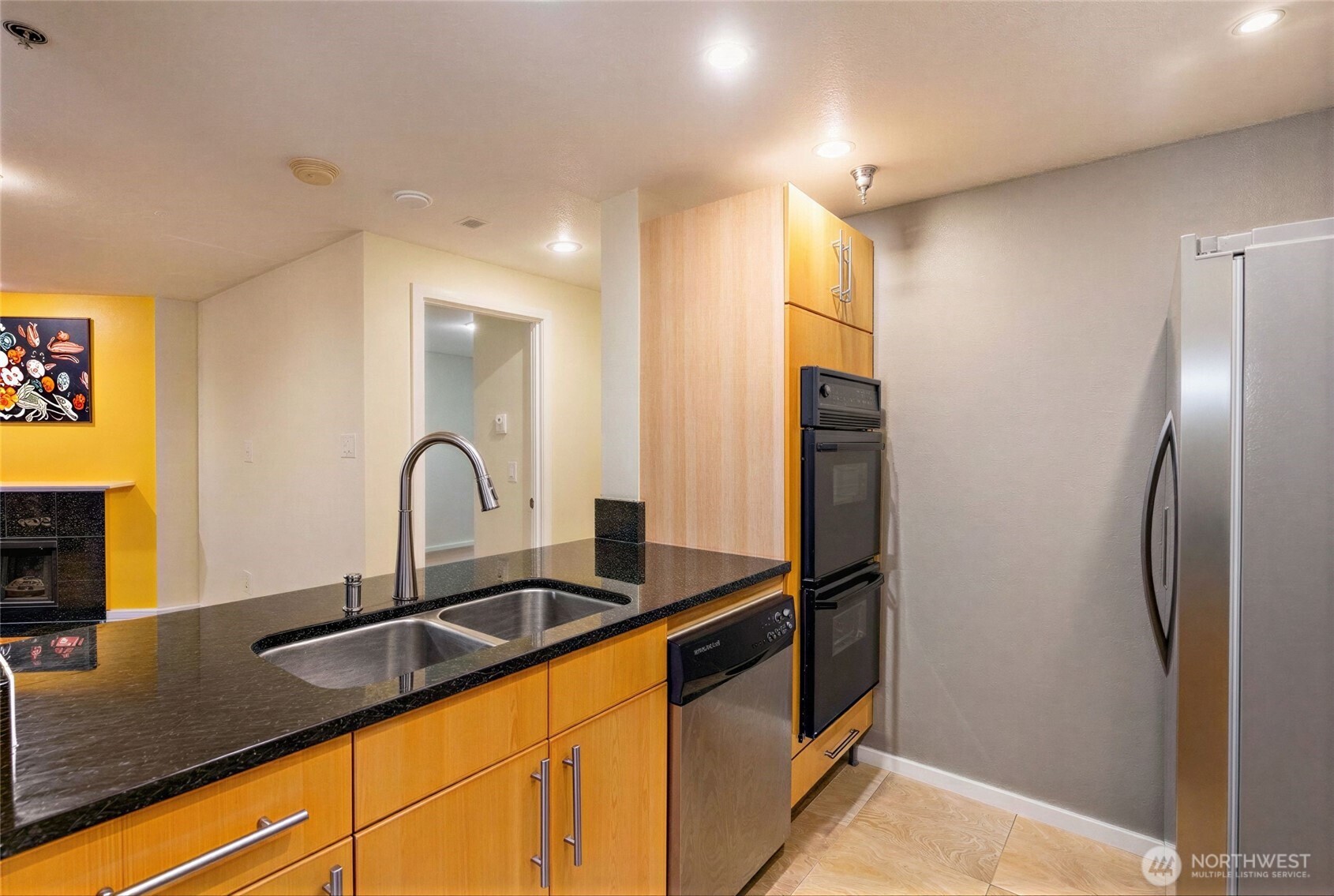 975 Aberdeen Avenue Northeast, Unit F207 Renton, WA 98056 - Photo 12 of 24 a kitchen with granite countertop a sink and stainless steel appliances