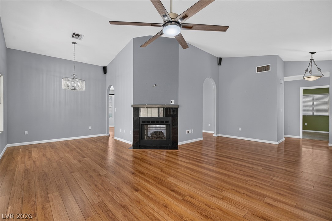 2609 Shakespeare Road Las Vegas, NV 89108 - Photo 7 of 41 A striking fireplace forms a focal point in this room, complemented by warm hardwood flooring.