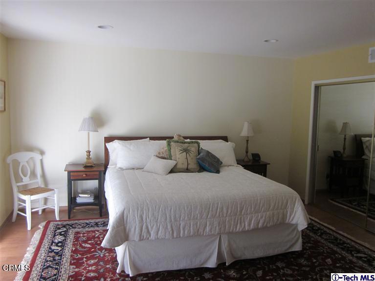 2716 Ridgepine Drive La Crescenta, CA 91214 - Photo 17 of 40 a large bed sitting in a bedroom next to a lamp