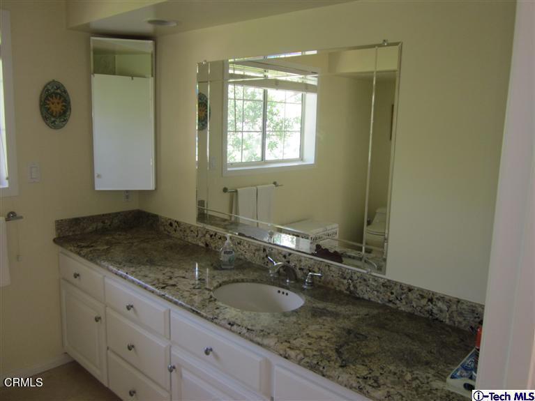 2716 Ridgepine Drive La Crescenta, CA 91214 - Photo 21 of 40 a bathroom with a granite countertop sink and a mirror