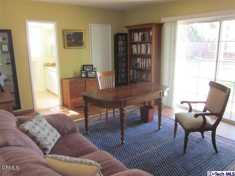 2716 Ridgepine Drive La Crescenta, CA 91214 - Photo 23 of 40 a living room with furniture a bookshelf and a window