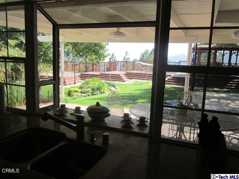 2716 Ridgepine Drive La Crescenta, CA 91214 - Photo 10 of 40 a room with a large window and a table chair in front of it