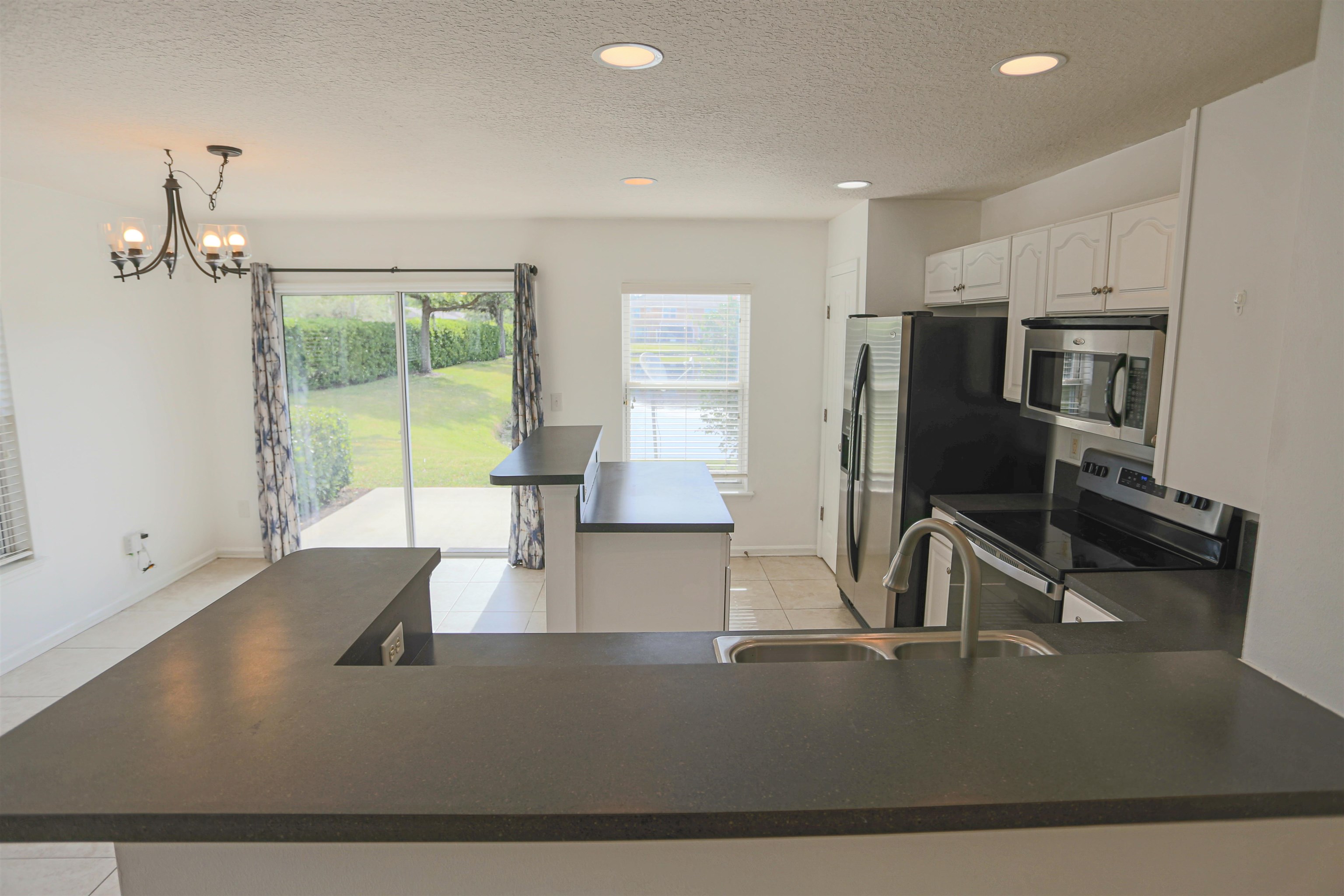 104 Crete Court St. Augustine, FL 32084 - Photo 11 of 32 a view of a kitchen with kitchen island a sink appliances and a counter top space