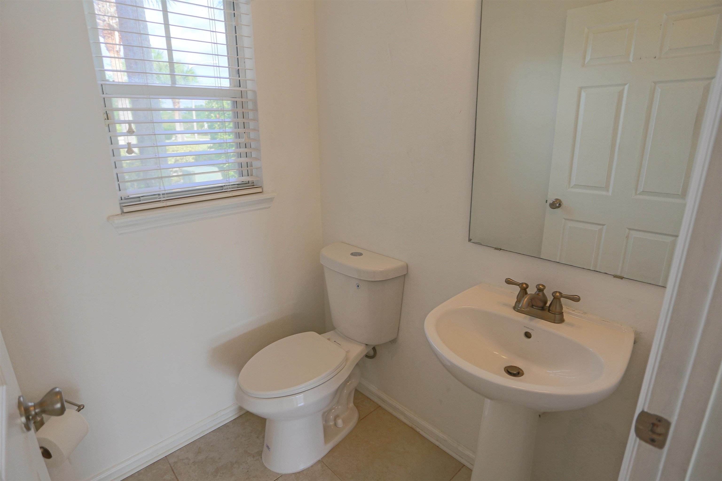 104 Crete Court St. Augustine, FL 32084 - Photo 14 of 32 a bathroom with a sink a toilet and a mirror