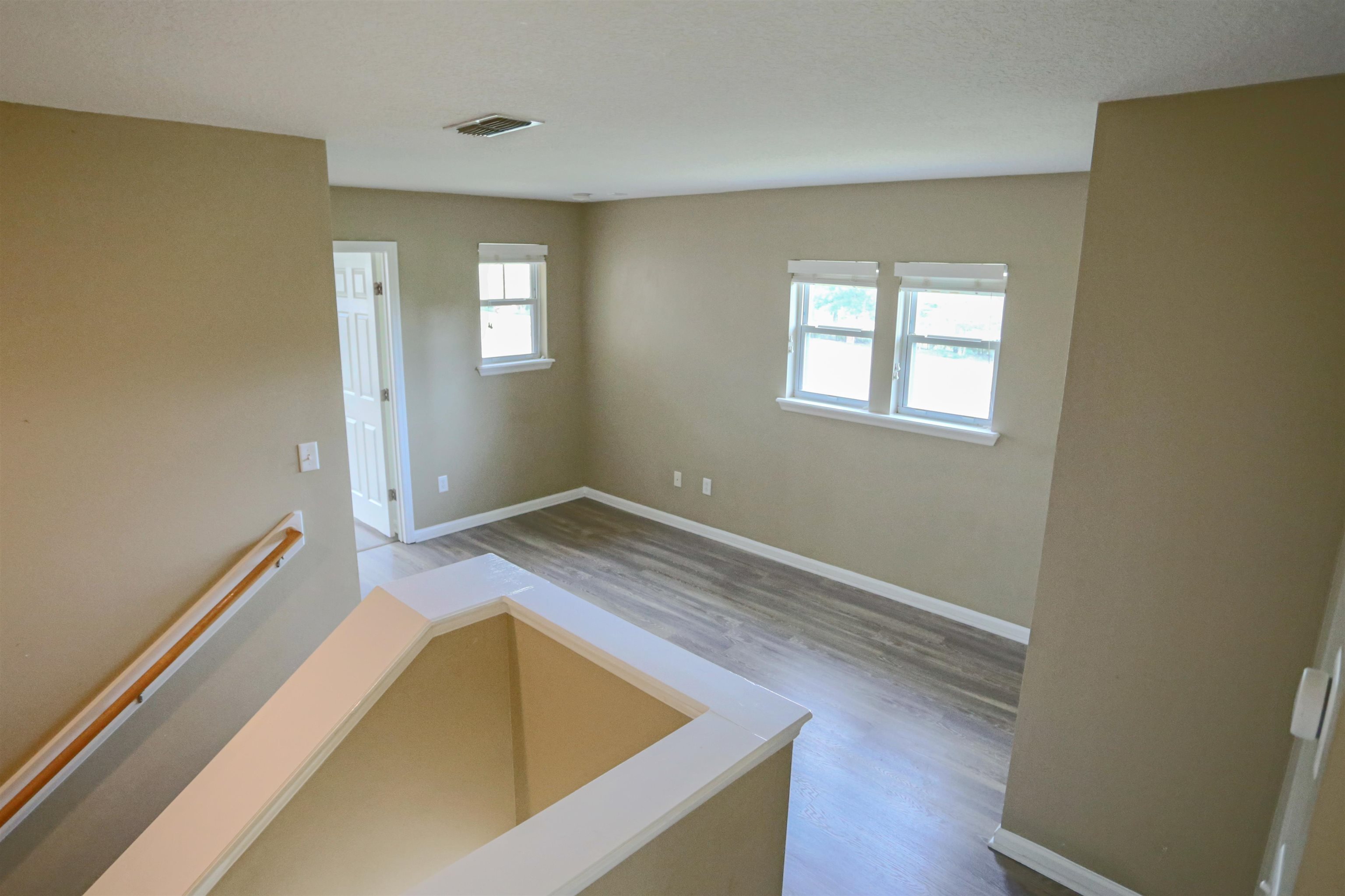 104 Crete Court St. Augustine, FL 32084 - Photo 15 of 32 a view of a bedroom with wooden floor and window