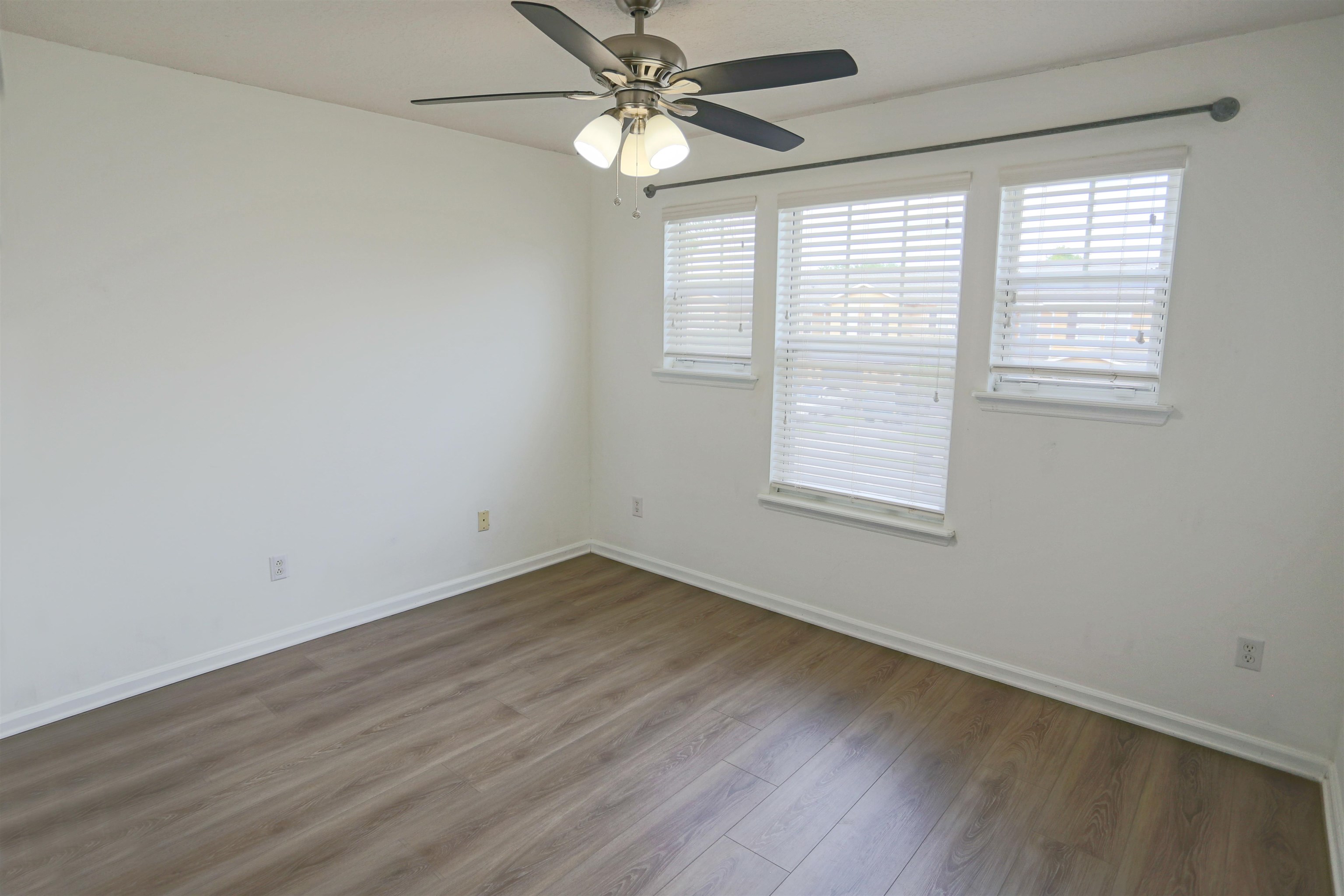 104 Crete Court St. Augustine, FL 32084 - Photo 25 of 32 an empty room with wooden floor fan and windows