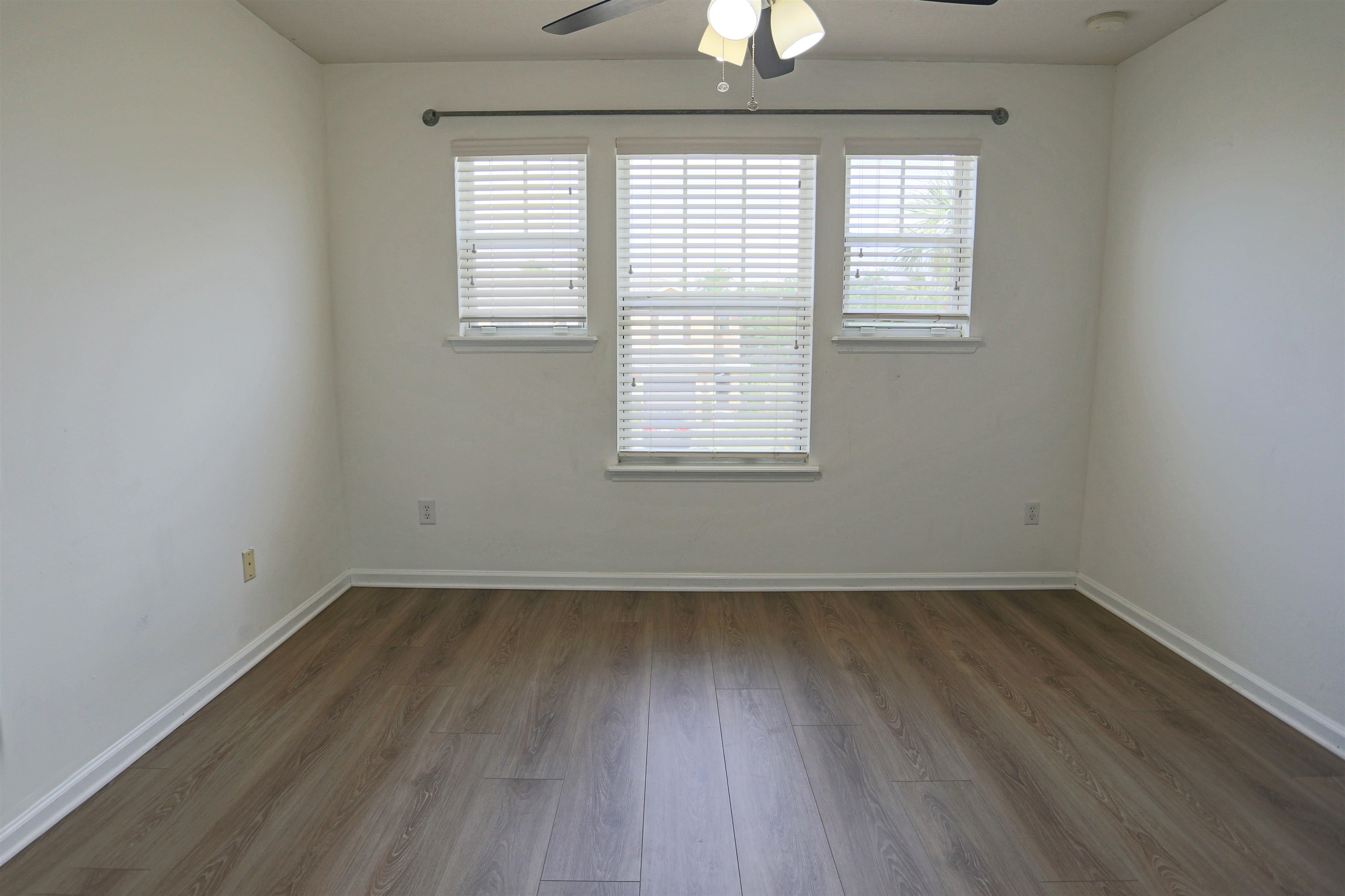 104 Crete Court St. Augustine, FL 32084 - Photo 26 of 32 an empty room with wooden floor and windows