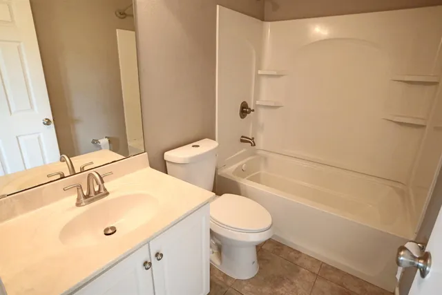 a bathroom with a sink mirror toilet and bathtub