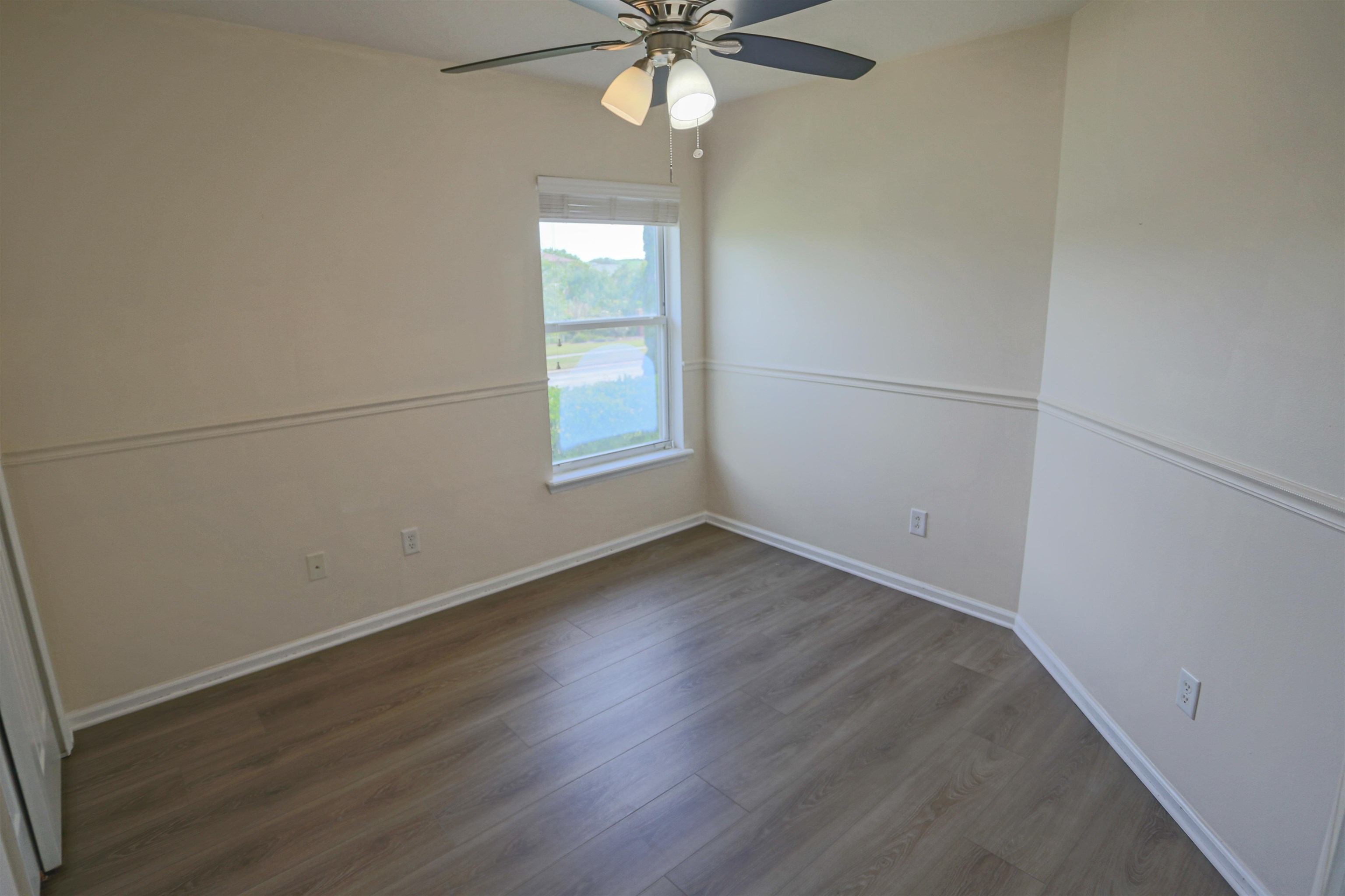 104 Crete Court St. Augustine, FL 32084 - Photo 29 of 32 an empty room with wooden floor fan and windows