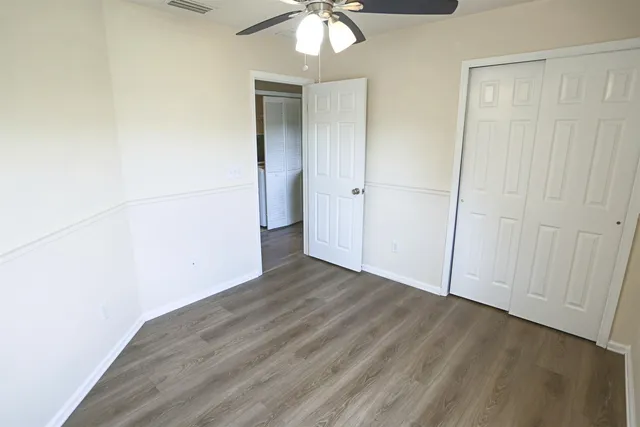 a view of a room with wooden floor