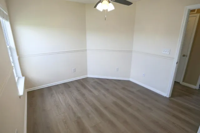 an empty room with wooden floor and door