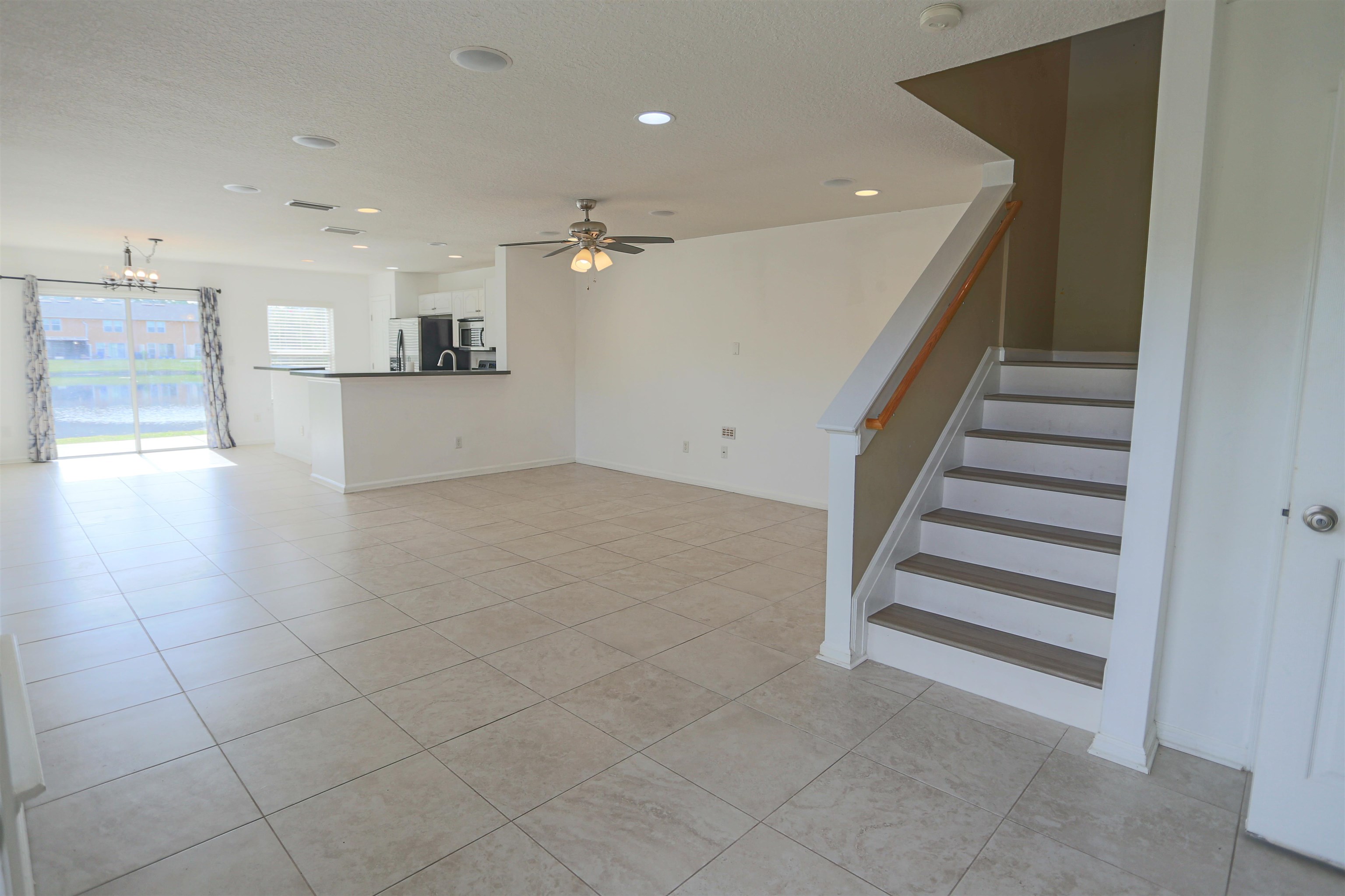 104 Crete Court St. Augustine, FL 32084 - Photo 7 of 32 a view of a hallway with stairs and a cabinet