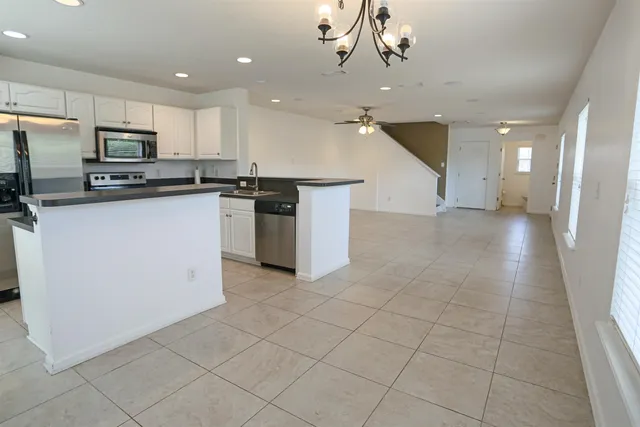 a kitchen with stainless steel appliances a refrigerator sink and microwave