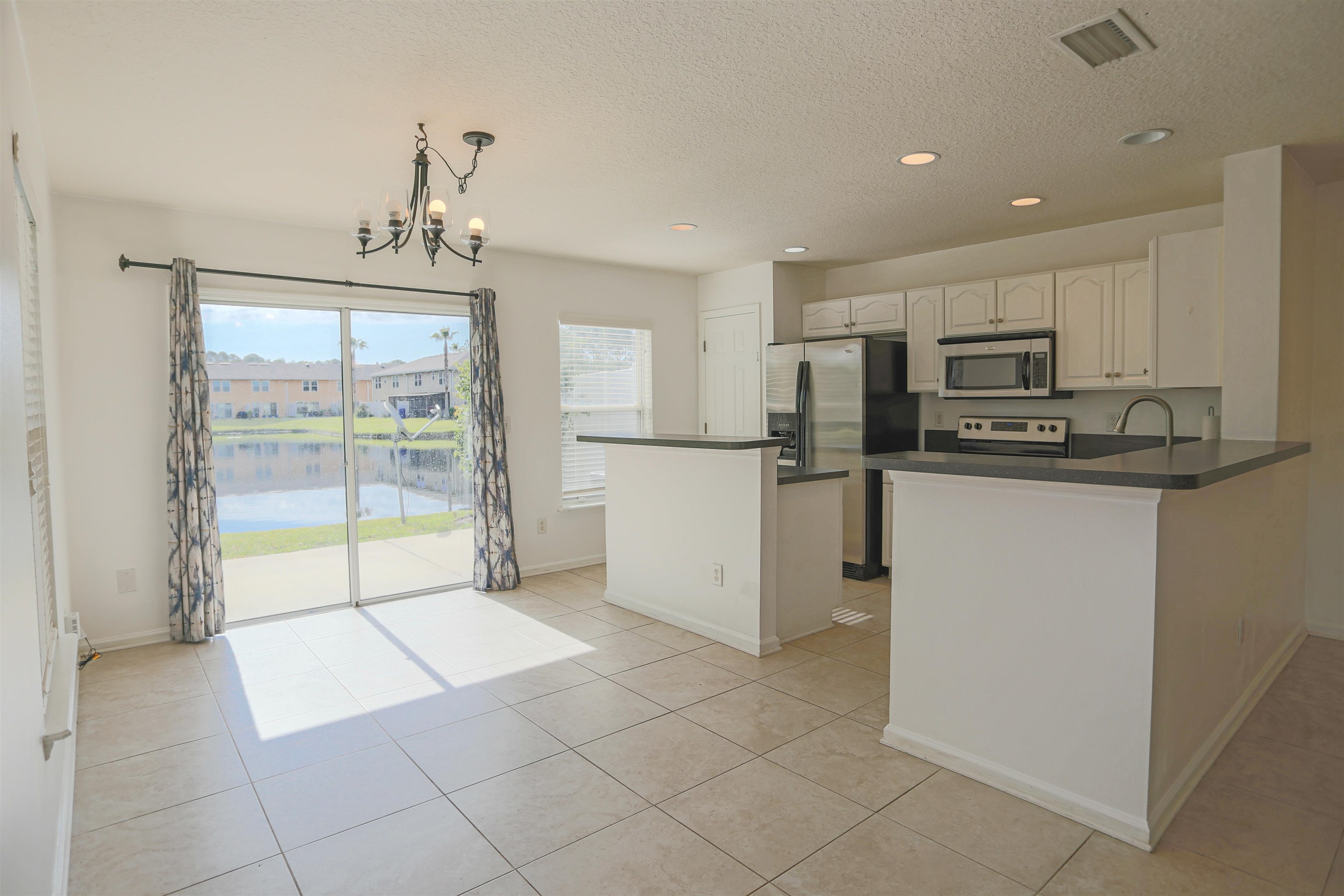 104 Crete Court St. Augustine, FL 32084 - Photo 10 of 32 a kitchen with stainless steel appliances granite countertop a refrigerator oven a sink and dishwasher