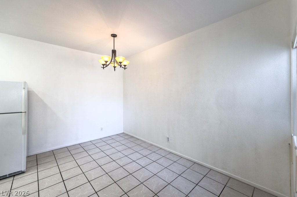 2201 Ramsgate Drive, Unit 1017 Henderson, NV 89074 - Photo 8 of 30 This versatile space features a timeless tiled floor and an elegant overhead chandelier, ready for personalization.