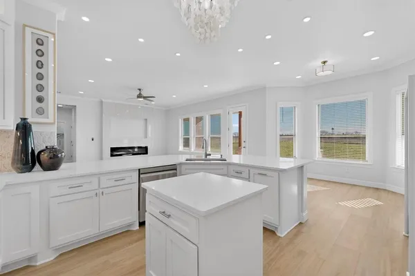 a kitchen with sink and cabinets
