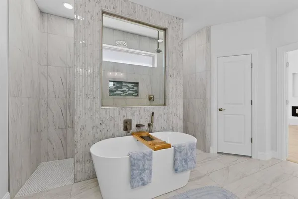 a spacious bathroom with a bathtub and shower