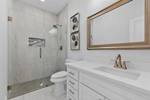 a bathroom with a toilet sink and shower