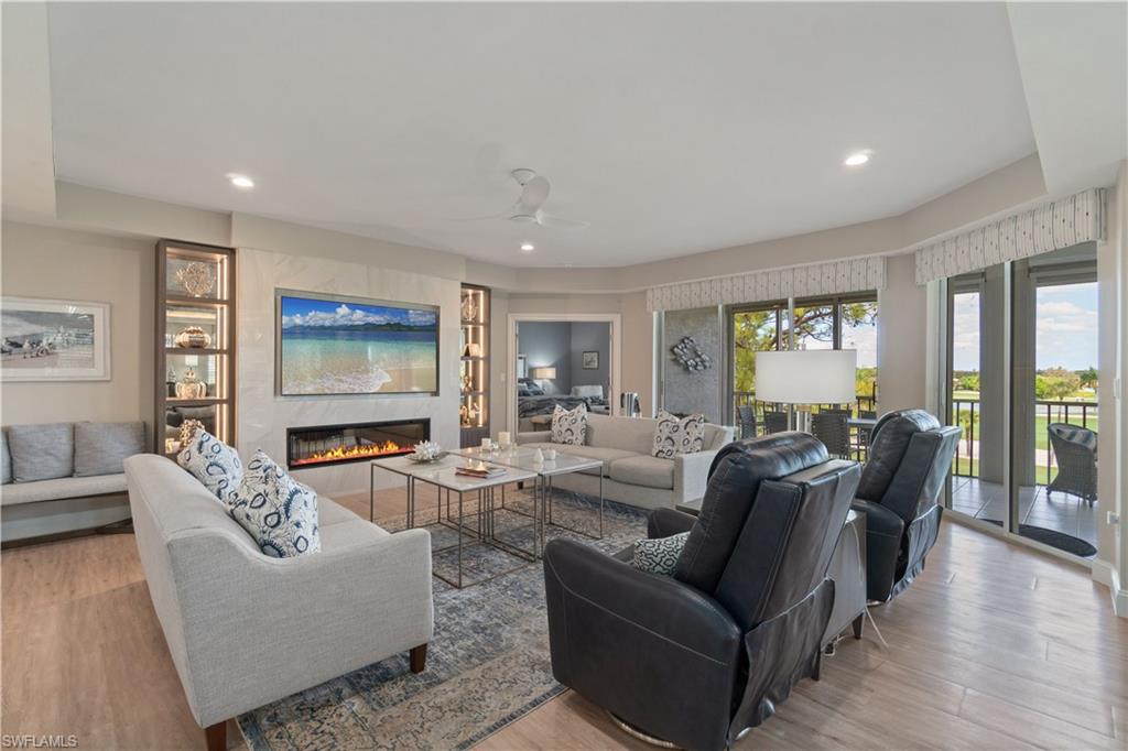 567 Audubon Boulevard, Unit D301 Naples, FL 34110 - Photo 3 of 37 Spacious living area with fireplace to warm you up when needed.