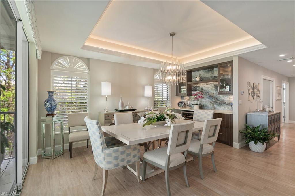 567 Audubon Boulevard, Unit D301 Naples, FL 34110 - Photo 4 of 37 Dining area with wet bar and wine cooler