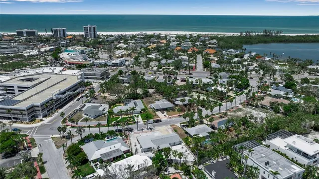 a view of an empty room with furniture and a large window