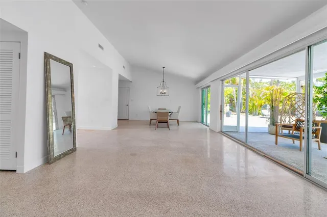a dining room with furniture and a window