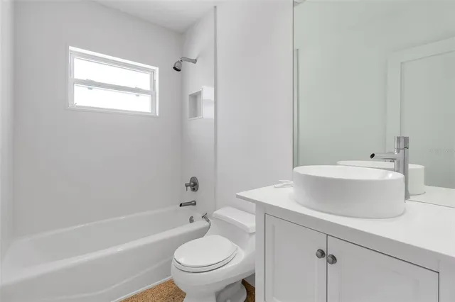 a view of a dry yard with a house in the background