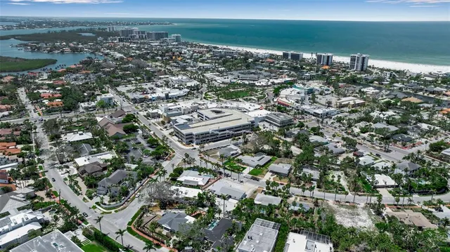 an aerial view of a house with a yard and lake view