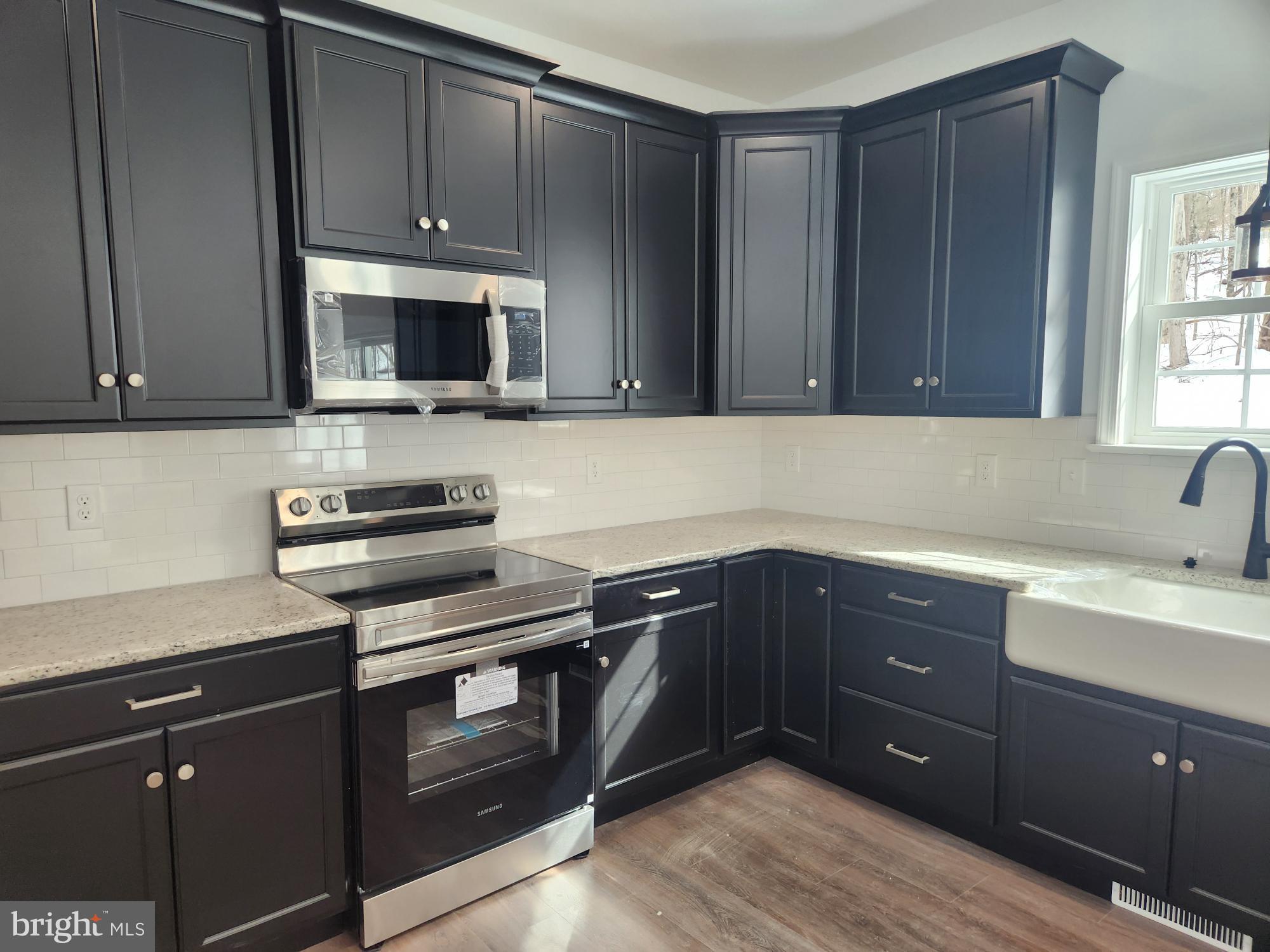 1929 Dunkleberger Road Elliottsburg, PA 17024 - Photo 6 of 48 Sleek modern kitchen with dark cabinetry.