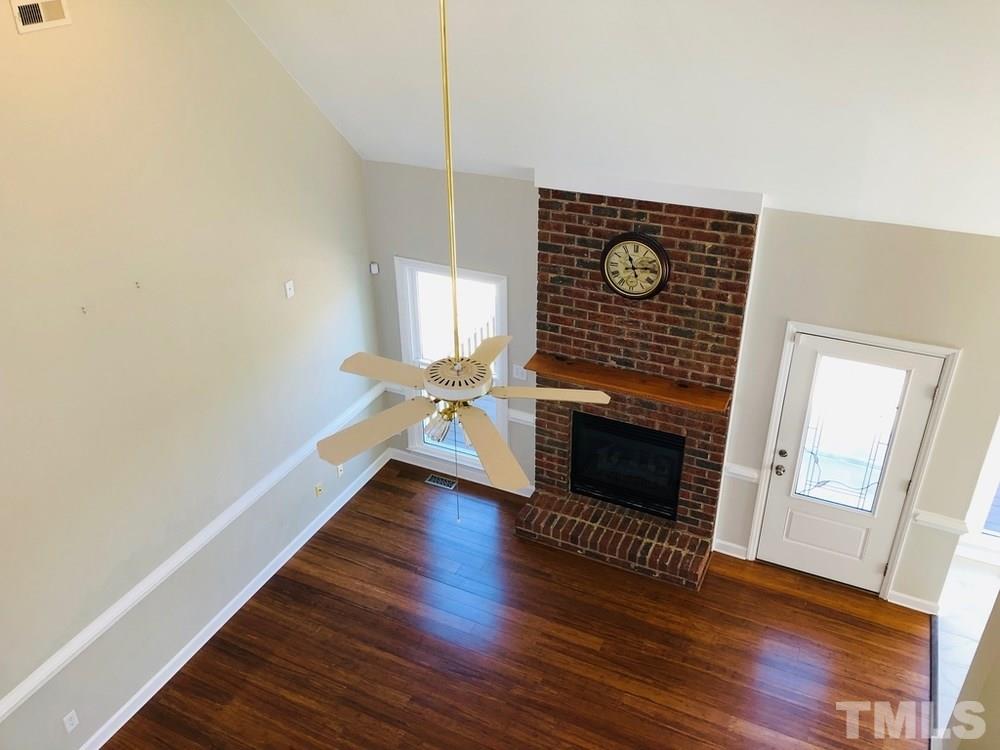 4309 Willow Lake Road Raleigh, NC 27616 - Photo 16 of 30 a view of an empty room with wooden floor fireplace and a window