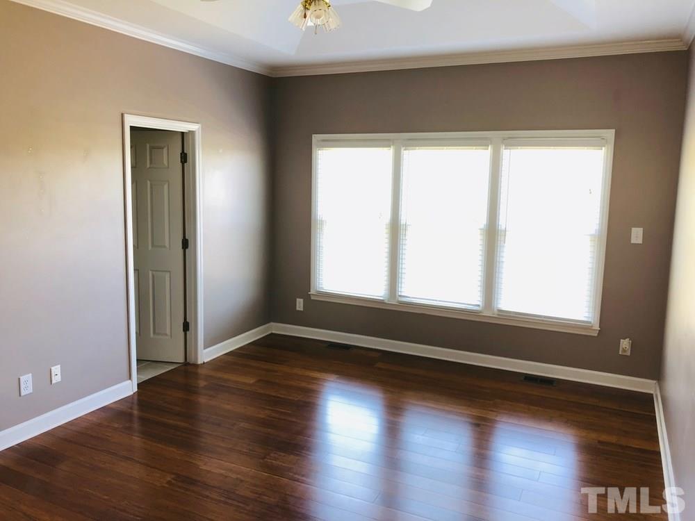 4309 Willow Lake Road Raleigh, NC 27616 - Photo 18 of 30 a view of an empty room with wooden floor and a window
