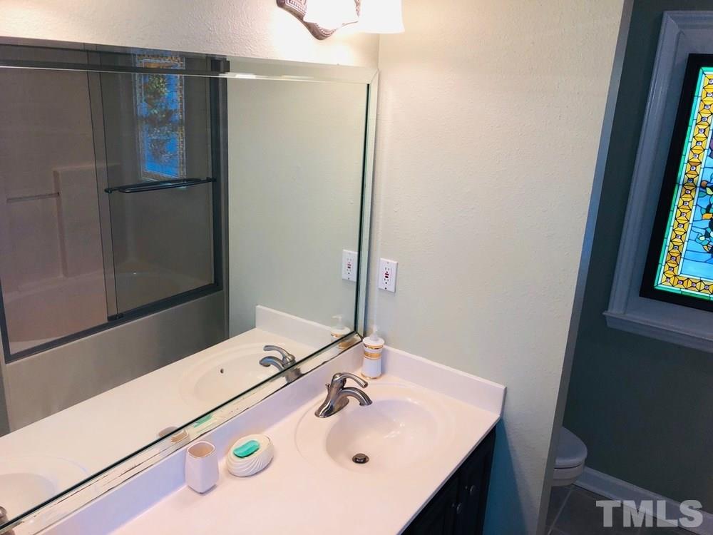 4309 Willow Lake Road Raleigh, NC 27616 - Photo 21 of 30 a bathroom with a sink and a mirror