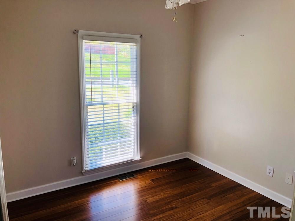 4309 Willow Lake Road Raleigh, NC 27616 - Photo 22 of 30 a view of an empty room with wooden floor and a window